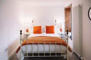 a bedroom with a bed with orange pillows at The Merchants House in Pittenweem