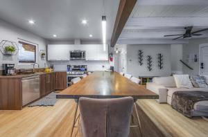 a kitchen and living room with a large wooden table at Zephyr Chalet Steps from Zephyr Cove in Glenbrook