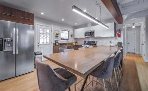 a large kitchen with a large wooden table and chairs at Zephyr Chalet Steps from Zephyr Cove in Glenbrook +27 photos