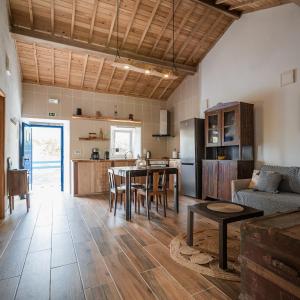 a kitchen and living room with a table and a couch at Villa Pico de Mafra in Mosteiros