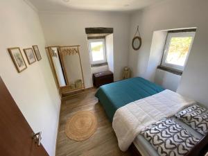 a bedroom with a bed and two mirrors at Villa Pico de Mafra in Mosteiros