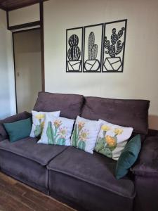 a brown couch with some pillows on it at Casa completa in Caçapava do Sul