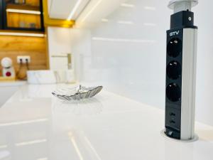 a appliance sitting on a counter in a kitchen at SOL LUX Tuzla in Tuzla +51 photos