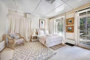 a bedroom with a bed and a chair and a window at Stunning Garden Studio at Mayfield Vineyard in Bloomfield
