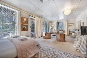 a bedroom with a bed and a living room at Stunning Garden Studio at Mayfield Vineyard in Bloomfield +7 photos