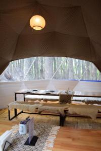 a room with a table and a large window at Fitz Roy Comfort Camp - El Chaltén in El Chalten