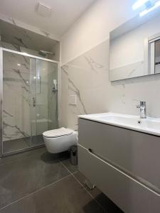 a bathroom with a toilet and a sink and a shower at Il Sogno in Como +31 photos