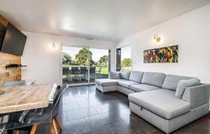 a living room with a couch and a table at Lovely Home In Lanvéoc in Lanvéoc