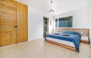 a bedroom with a bed and a large window at Lovely Home In Lanvéoc in Lanvéoc