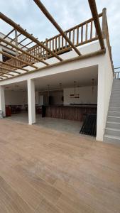 an empty building with a wooden floor and stairs at Maramar Beach House in Luis Correia