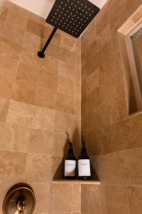 two bottles of soap sitting on a shelf in a shower at Apartamento en Los Cabos - Misiones del Cabo in Cabo San Lucas +4 photos