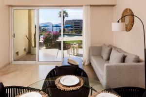 a living room with a glass table and a couch at Apartamento en Los Cabos - Misiones del Cabo in Cabo San Lucas