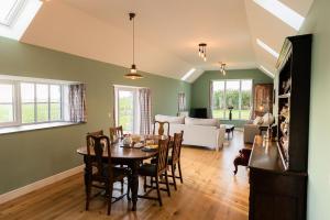 a dining room with a table and a living room at Dale, Burray, Orkney - OR00597F in Burray Village