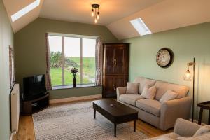 a living room with a couch and a tv at Dale, Burray, Orkney - OR00597F in Burray Village