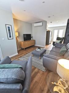 a living room with a couch and a tv at 6 Zetland Road, Kirkwall, Orkney - OR00275F in Kirkwall