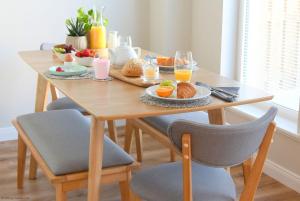a wooden table with breakfast foods and drinks on it at 6 Zetland Road, Kirkwall, Orkney - OR00275F in Kirkwall