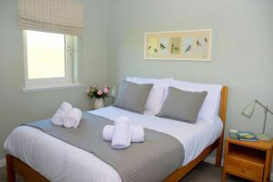 a bedroom with a bed with towels on it at 6 Zetland Road, Kirkwall, Orkney - OR00275F in Kirkwall