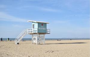 a life guard tower on the beach at Maison Avec Piscine Couverte in Fervaques +18 photos