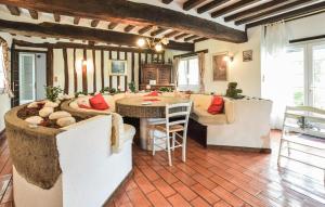 a living room with a large bed and a table at Maison Avec Piscine Couverte in Fervaques