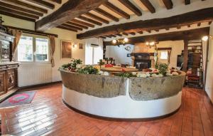 a large kitchen with a large tub in the middle of a room at Maison Avec Piscine Couverte in Fervaques