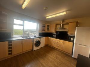 a kitchen with a washer and a sink and a window at Cunningair, Kirkwall, Orkney - OR00447F in Kirkwall +5 photos