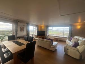 a living room with a table and chairs and a dining room at Cunningair, Kirkwall, Orkney - OR00447F in Kirkwall