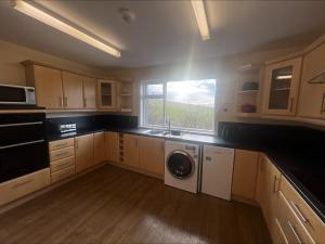 a kitchen with a washing machine and a window at Cunningair, Kirkwall, Orkney - OR00447F in Kirkwall