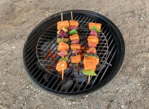 a bunch of skewers cooking on a grill at Lariat Motel in Moriarty