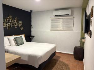 a small bedroom with a bed and a window at OJAS Compact Studio in San Juan