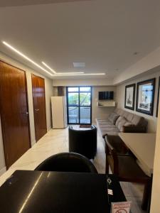a living room with a couch and a table at Flat tambau in João Pessoa