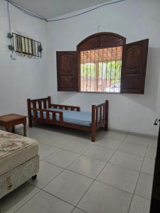 a bedroom with two beds and a window at Marahu Lindinhos in Belém