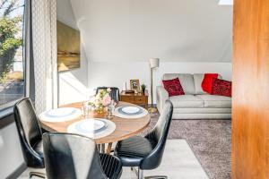 a living room with a table and chairs and a couch at Walkable Location, Historic Setting: Warrenton Apt in Warrenton +17 photos
