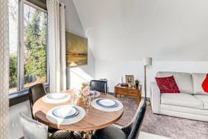 a living room with a table and chairs and a couch at Walkable Location, Historic Setting: Warrenton Apt in Warrenton