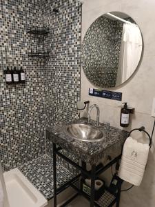 a bathroom with a sink and a mirror at Distrito A by Fma Coliving in Salta +38 photos