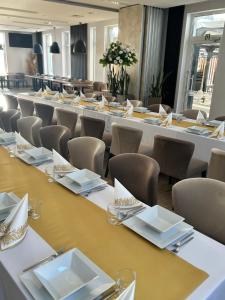 a conference room with long tables and chairs at Blu Residence in Zielona Góra +13 photos