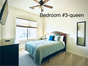 a bedroom with a bed with a ceiling fan and a window at Spacious Home in Page
