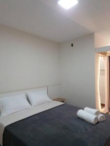 a bedroom with a bed with two towels on it at Riviera Sanary 1207 Nova Almeida in Serra +23 photos