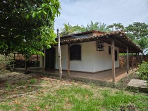 a small white house with a wooden porch at Marahu Lindinhos in Belém