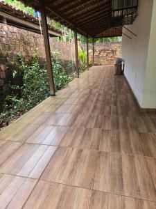 an empty porch with a wooden floor in a building at Marahu Lindinhos in Belém +4 photos