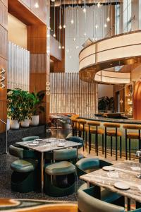 a restaurant with tables and chairs and a bar at W Hoboken in Hoboken