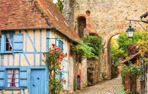 an old house with a blue door on a street at Authentique Ferme En Campagne in Saint-Germer-de-Fly