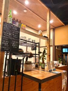 a table with a chalkboard on top of it at GROUNDWORK Guesthouse & Lounge in Yugawara
