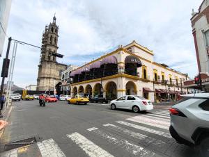 a city street with a clock tower and a building at Casona Imperial in Tepic