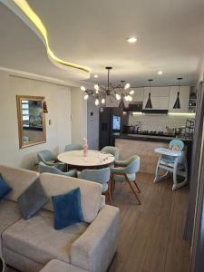 a living room with a couch and a table at Beach House - Besso Beach in Barranca
