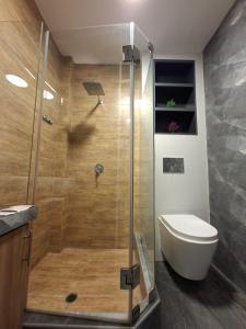 a bathroom with a shower with a toilet and a sink at Beach House - Besso Beach in Barranca +19 photos