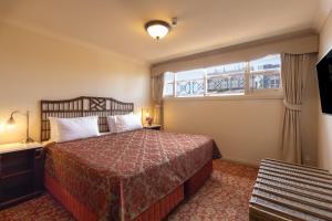 a hotel room with a bed and a window at Hadley's Orient Hotel in Hobart +68 photos