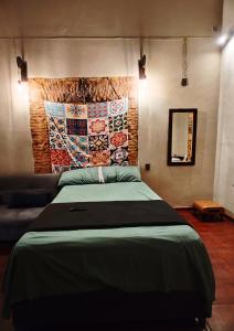a bedroom with a large bed and a mirror at Casona Imperial in Tepic