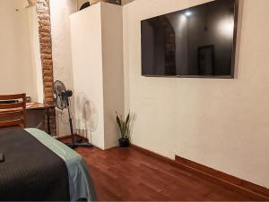 a bedroom with a bed and a large mirror on the wall at Casona Imperial in Tepic