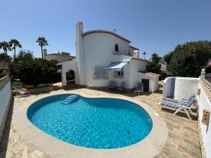 a large swimming pool in front of a house at La Duna de Denia in Denia