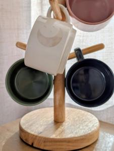 a mortar and pestle on a wooden stand with two pots at Golden Moon Hideaway in Twentynine Palms